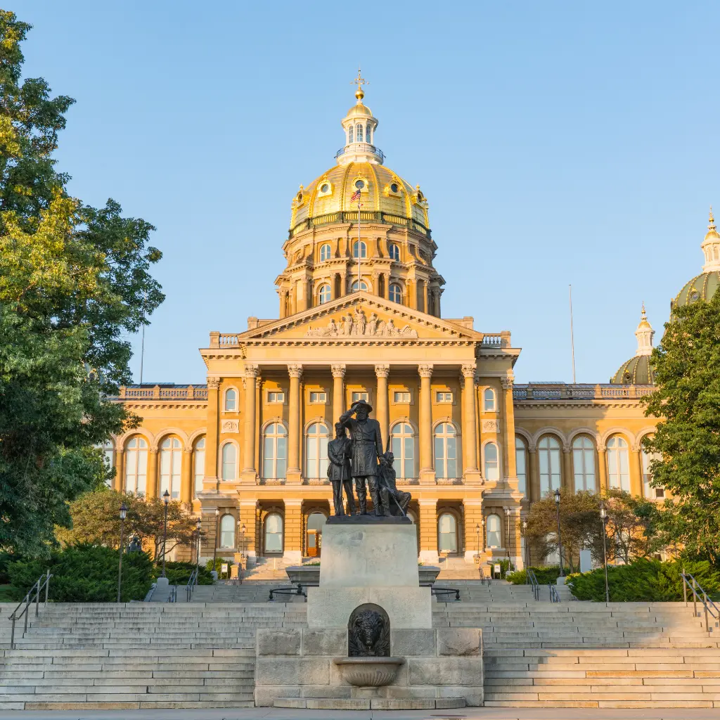 iowa State Capitol in Des Moines with its golden dome and statue in front. Transportvibe