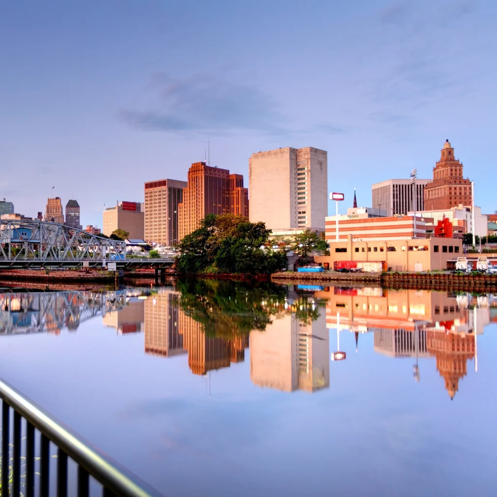 Newark skyline reflecting on the Passaic River at dusk in New Jersey. Transportvibe