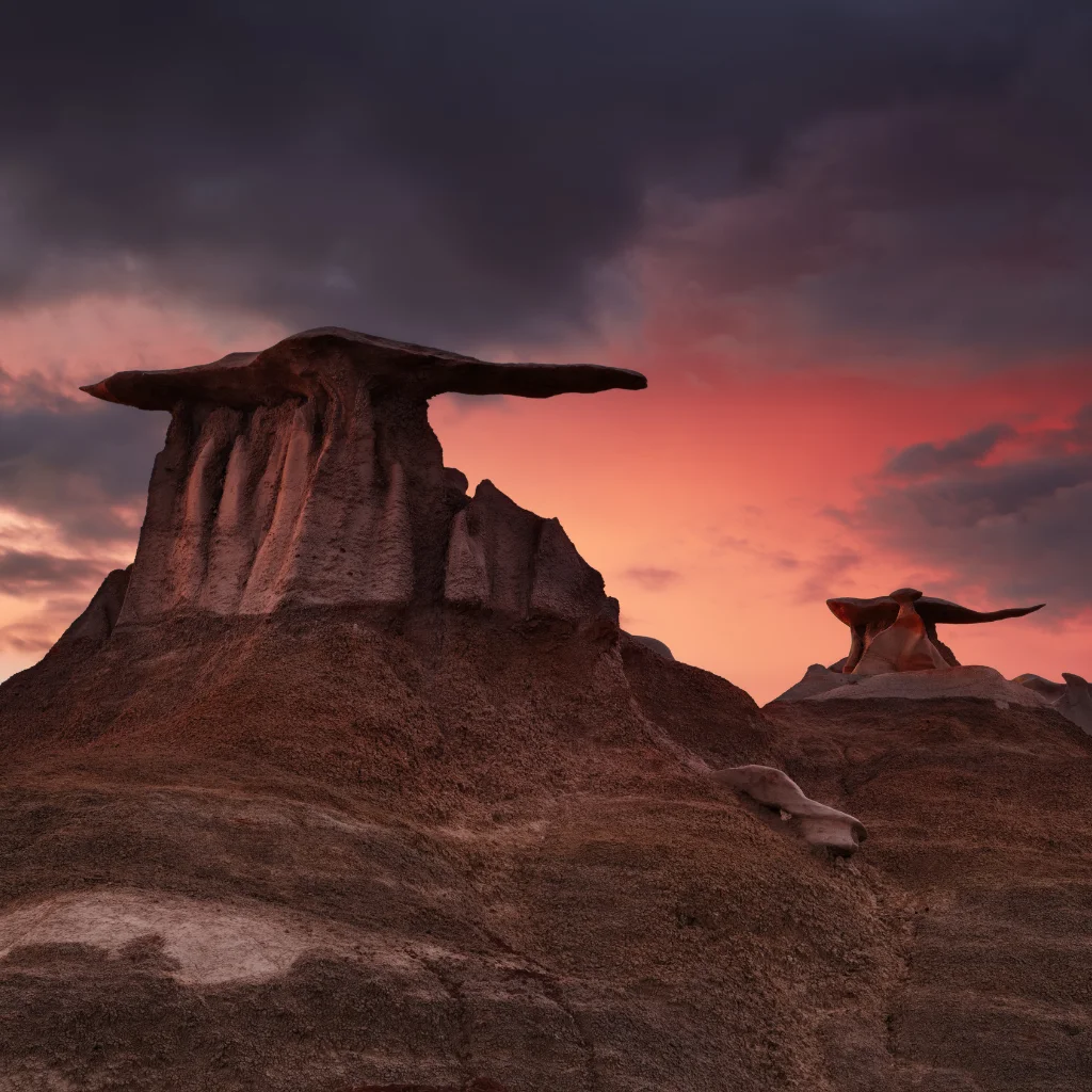 Bisti Badlands in New Mexico with unique rock formations at sunset. Transportvibe
