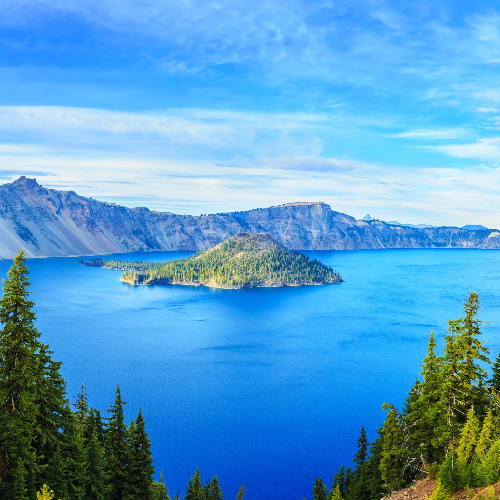 Crater Lake in Oregon with deep blue water and Wizard Island. Transportvibe