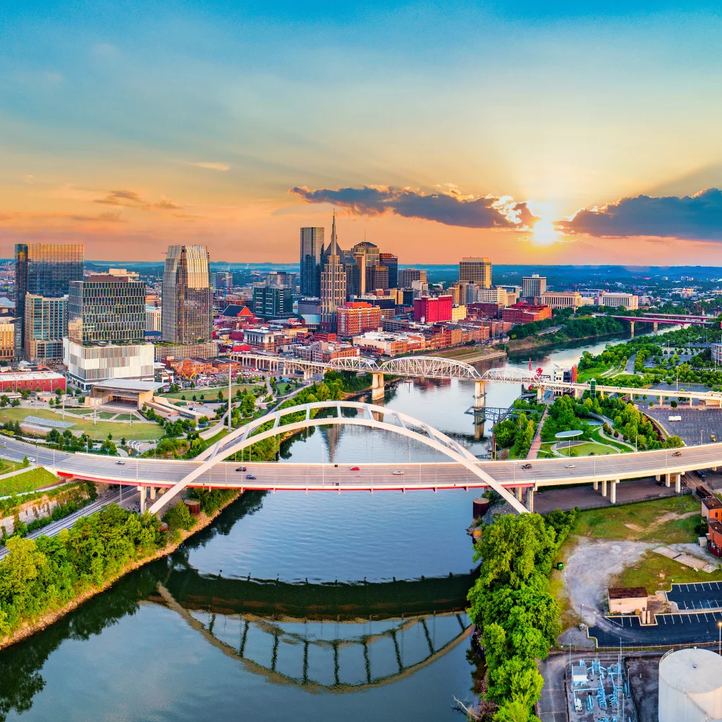 Nashville tennessee skyline at sunset with bridges over the Cumberland River. Transportvibe