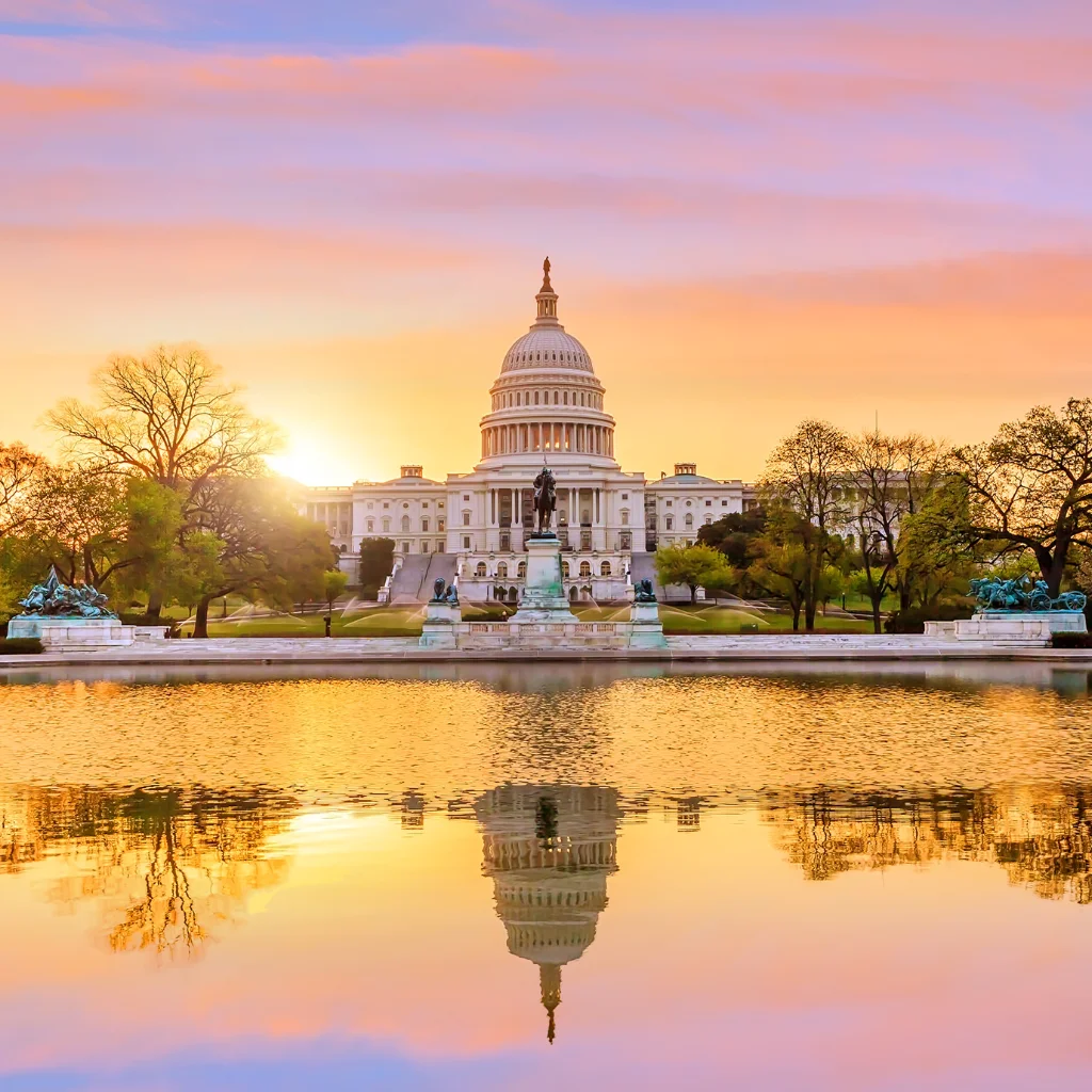 U.S. Capitol in Washington, D.C., reflecting in water at sunset. Transportvibe