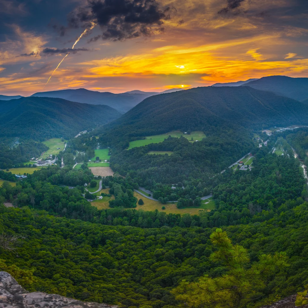 A scenic view of West Virginia’s lush mountains and valleys at sunset. Transportvibe