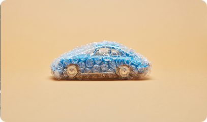 A large blue cargo ship loaded with colorful shipping containers sailing across the open sea with another vessel in the background. Transportvibe 3