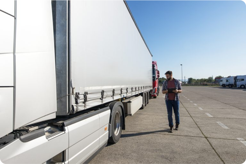 truck driver inspecting vehicle trailer tires before driving 768x513.jpg