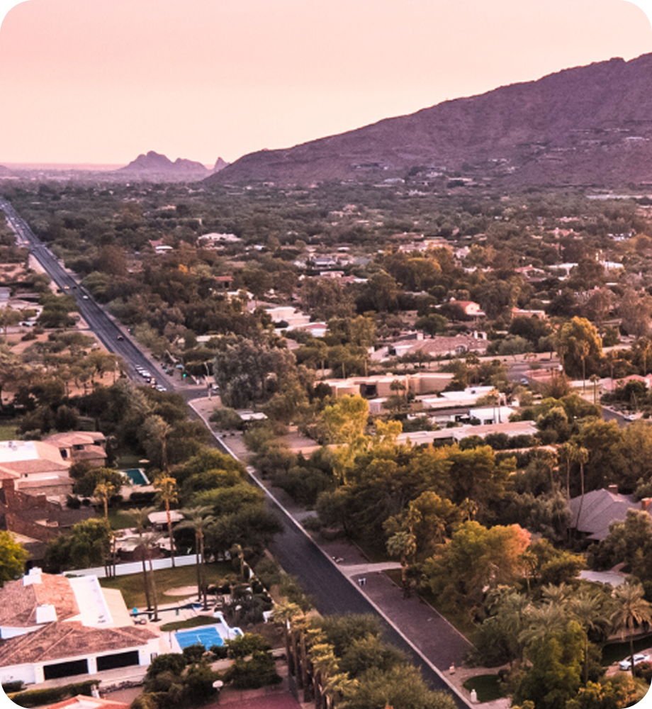 A breathtaking view of snow covered mountain peaks in Alaska with rugged slopes and a clear blue sky above. Transportvibe